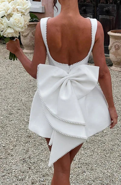 Pearl Trim Sleeveless Slim Fit Mini Dress with Statement Bow Back