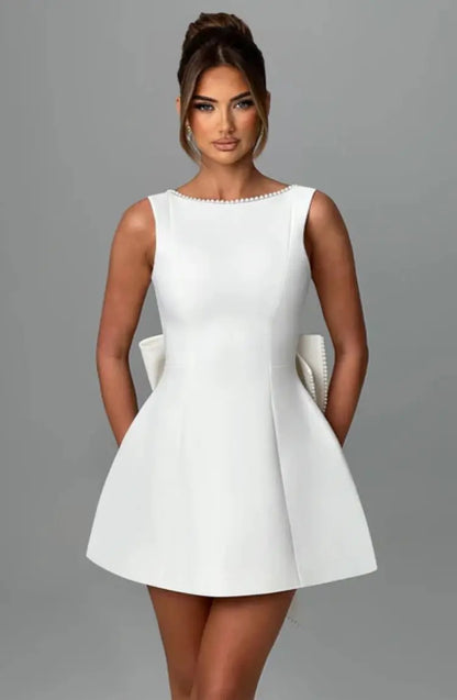 Pearl Trim Sleeveless Slim Fit Mini Dress with Statement Bow Back