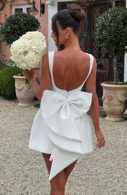 Pearl Trim Sleeveless Slim Fit Mini Dress with Statement Bow Back